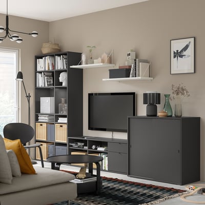 Modern living room: black VIHALS storage units, tv, sofa, & decor. Clean, cohesive design.
