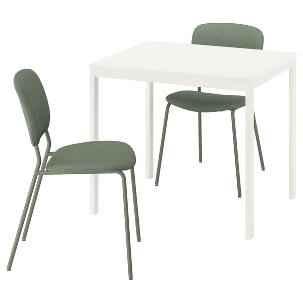 A white VIHALS extendable dining table with two green fabric chairs.