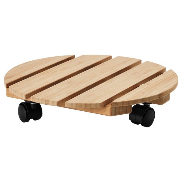 VILDAPEL wooden plant mover with round shape and black wheels.