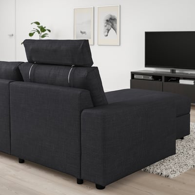 Black VIMLE modular sofa in living room, featuring a reclining chaise longue and adjustable headrest.