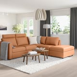Modern living room with orange VIMLE sectional sofa, foam cushions, coffee tables, rug, and plants.