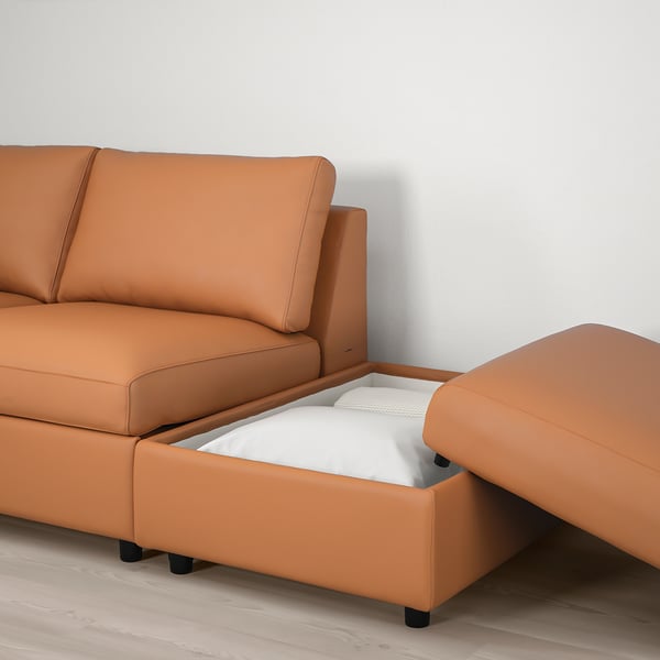 Sofa with pull-out ottoman and storage. Tan leather, comfortable, with headrest support.