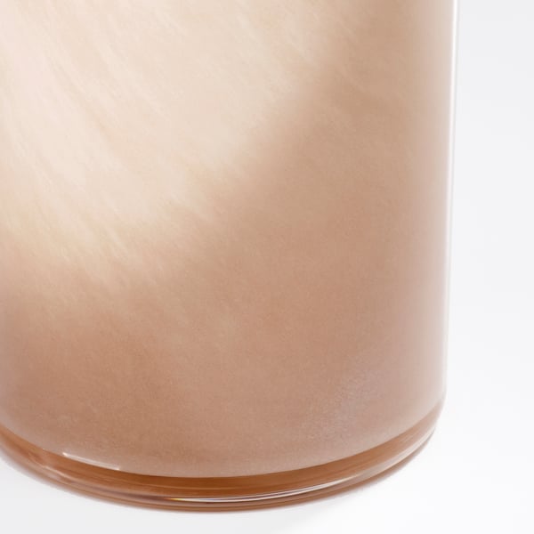 Handcrafted glass vase with warm hue and mouth-blown texture.