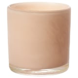 The VINDSTILLA candle is a handcrafted peach-colored glass holder, uniquely shaped and patterned.