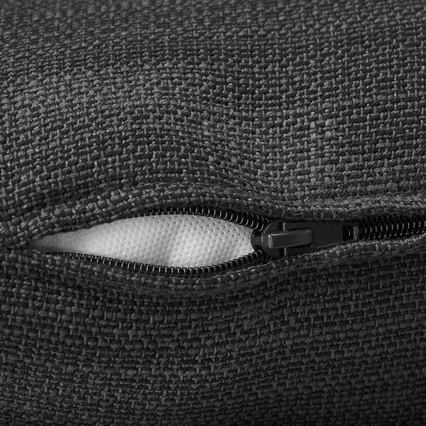 Close-up of a high-quality zipper on a soft, textured fabric sofa.