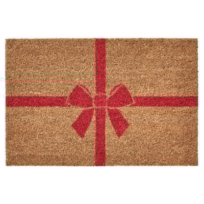 Red and beige rectangular doormat, shaped like a gift with a bow.