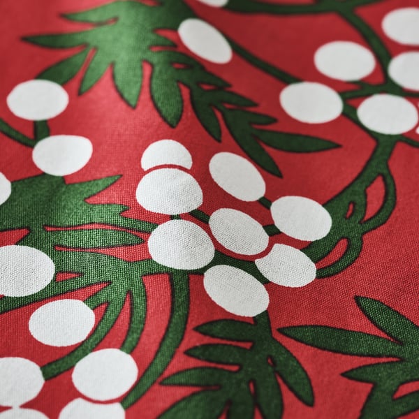 Bright red tablecloth with green leaves and white berries, high quality cotton texture.