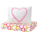 Heart-shaped pillow in vibrant colors on white background. Made from sustainable cotton.