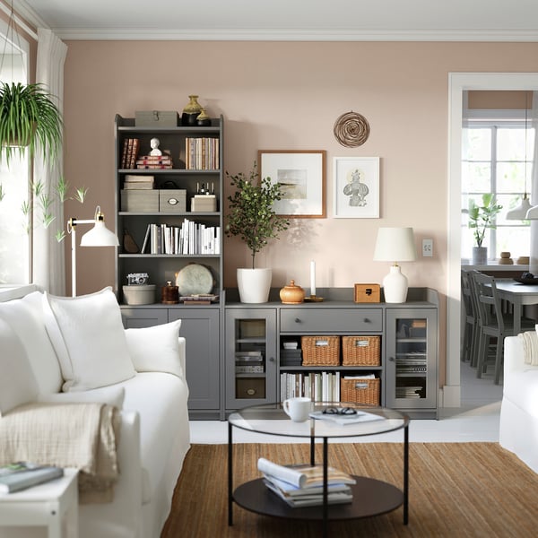VITTSJÖ glass coffee table in living room, modern & functional, stores items & blends with earthy tones.