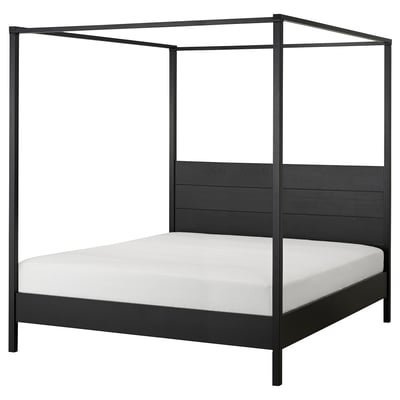 Black wooden bed frame with four posts, sleek design, adjustable, solid pine.
