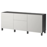 En ikea BESTÅ skænk, hvid med sorte ben, med to låger og skuffer.