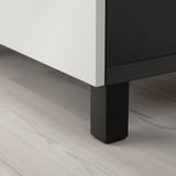 Moderne skab med minimalistisk design; hvid og mørk træfinish, robuste sorte ben.