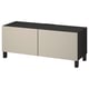 En ikea BESTÅ tv-bænk. Dens rektangulære, sorte på toppen, beige forneden, med 2 døre og 4 ben.