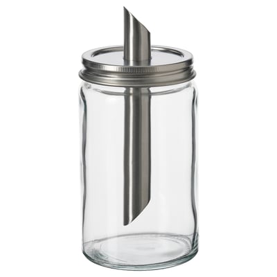 En tom, gennemsigtig sukkerbøsse i glas med låg i rustfrit stål og et metalrør, designet af IKEA.