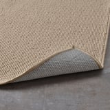 Bademåtte med beige og grå, struktureret overflade. Latexbagside forhindrer glidning.