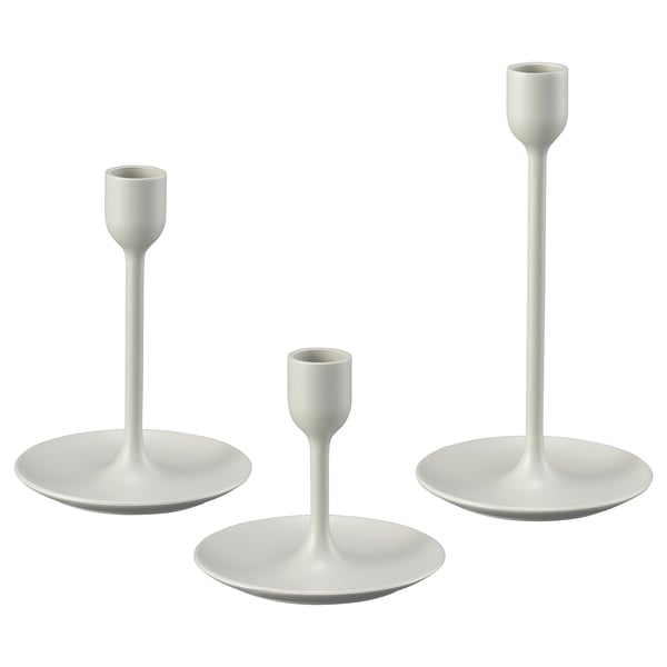 Tre hvide lysestager i varierende højder; moderne design, metalhus med filtbaser.