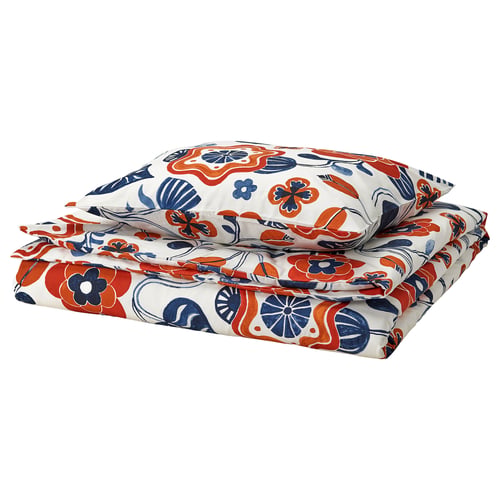 Et KANONVISKA blomstret dynesæt, hvidt med orange, blå og marineblå nuancer. Bomuld-viskoseblanding for komfort. Rektangulær med dekorative kanter.