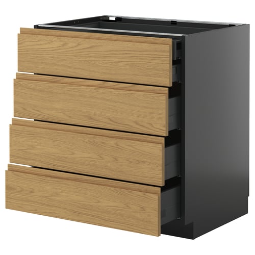 Et moderne køkkenskab i sort og træ med fire skuffer, der kombinerer mørke og lyse toner for et elegant look.