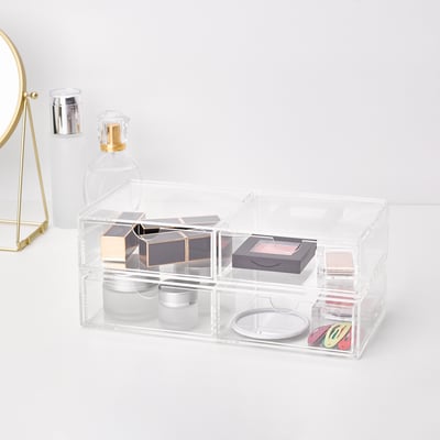 Klar akryl opbevaringsboks med 2 skuffer, der organiserer makeup og smykker.