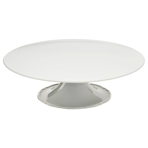 Et hvidt UPPLAGA porcelænskagefad med et flæsekantdesign, perfekt til elegant servering af lækkerier.