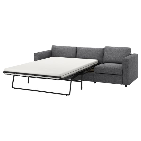 En grå VIMLE sovesofa, et alsidigt møbel med en foldemadras for ekstra soveplads.