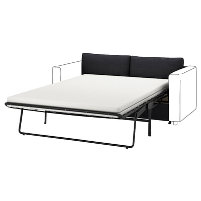 En VIMLE sovesofa med et sort/hvidt farvetema, med et moderne, kantet design og metalstel.