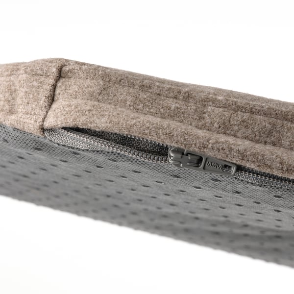 Close-up of recycled fabric chair cushion with quality zip detail.