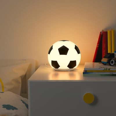 ÄNGARNA lamp: spherical, black & white on dresser, lights bed with yellow pillow. Kids room decor.