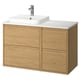 Modern wooden bathroom vanity in oak, featuring four drawers and a marble countertop with a square white sink and chrome faucet.