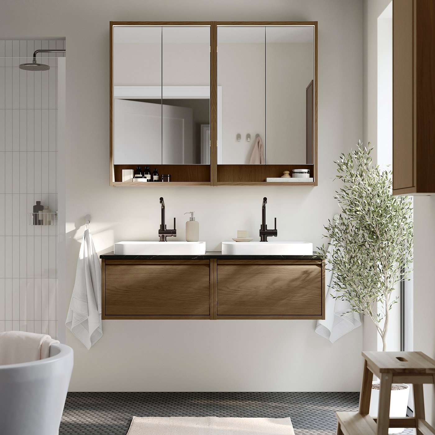 Modern bathroom with ÄNGSJÖN double vanity, two sinks, mirror cabinet, shower, stool, plant.