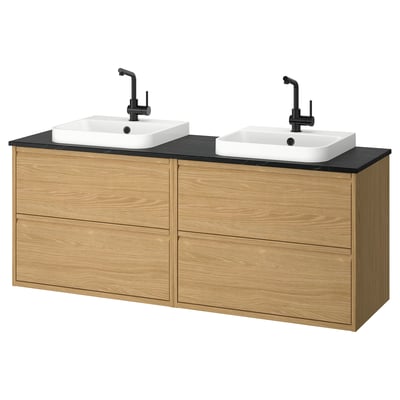 Modern double bathroom vanity, light wood, black counter, two white sinks, matte black faucets.