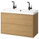 Modern bathroom vanity: ÄNGSJÖN in oak, wall-mounted with two drawers, white basin, black faucets.