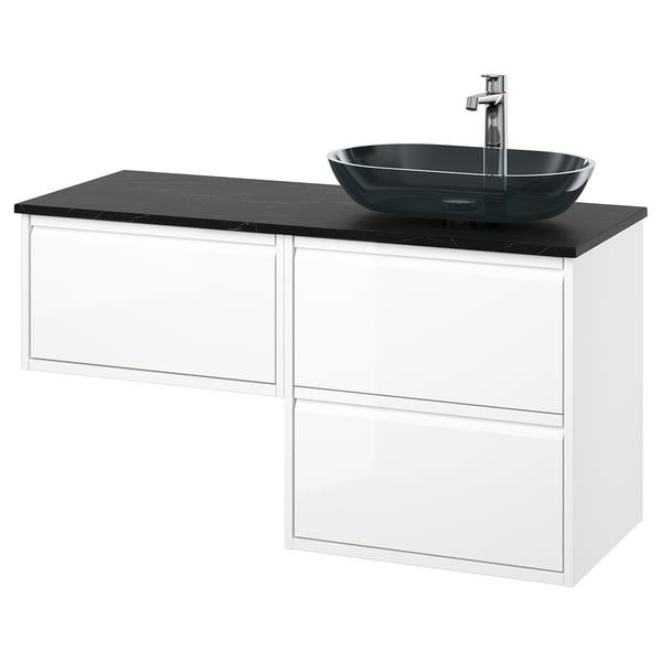 Modern white bathroom vanity with three drawers, black marble countertop, and oval black glass basin.