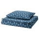 Blue geometric bedding set; square pillows, rounded shapes.