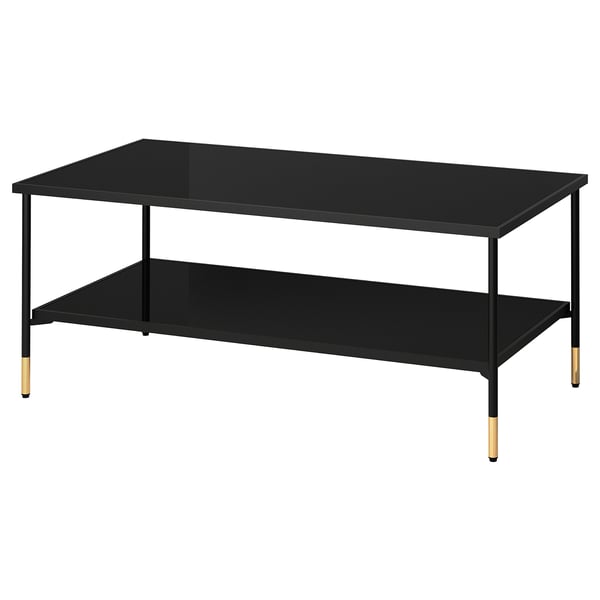 Modern coffee table with black smoked glass top and gold legs.