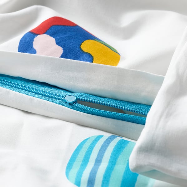 Close-up of a white duvet cover with colourful planet designs, featuring a blue zip. Part of the AFTONSPARV collection.