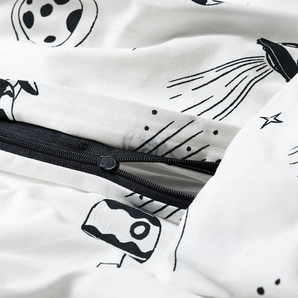 Black-and-white spaceship-patterned duvet with zip on white fabric.