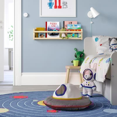 Childs blue room with AFTONSPARV toy, astronaut bed, books, and stool.