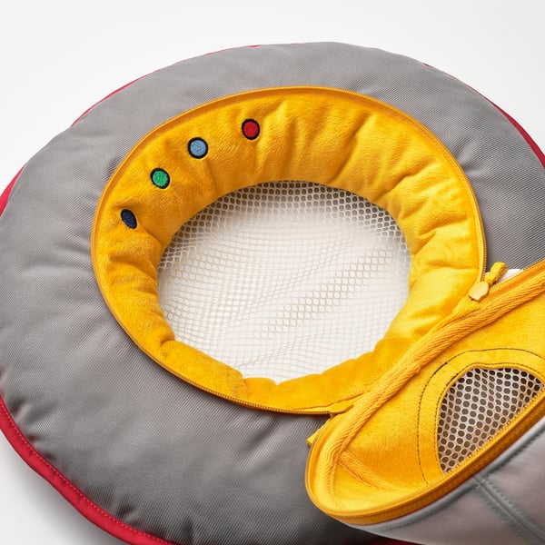 Spaceship soft toy with vibrant yellow interior, mesh centre, and plush fabric, showcasing quality and comfort.