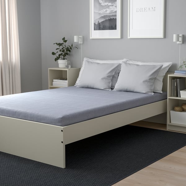 Grey ÅGOTNES foam mattress on white platform bed, 10 cm high, firm with soft top layer.