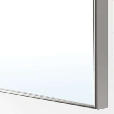 Corner of sleek, modern mirror door with smooth finish and clean lines.