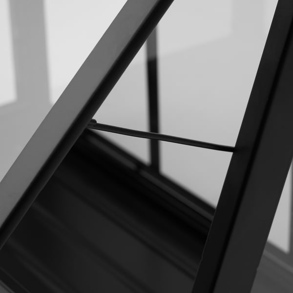 Modern black metal greenhouse frame close-up. Industrial design with clean lines and durable materials.