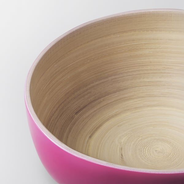 Close-up of a durable, smooth-edged pink bamboo bowl, showcasing its natural grain and quality craftsmanship.