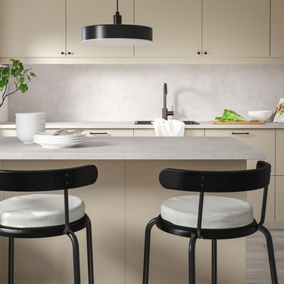 Modern kitchen with beige ÅKERVINDEFLY chair pads, memory foam for comfort, non-slip backing. Pads are small, fit neatly under counter stools.