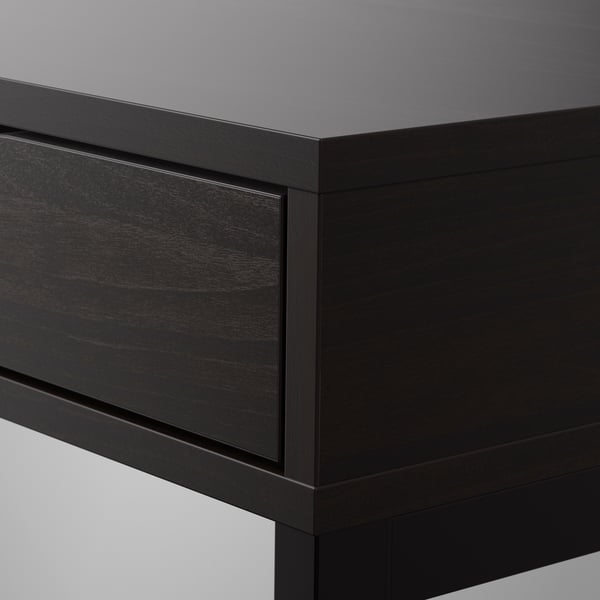 Close-up of sleek, modern black desk corner; smooth finish, sturdy design.