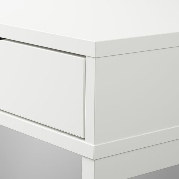 Modern white desk with sleek edges and built-in drawers, ensuring a minimalist design and efficient storage.
