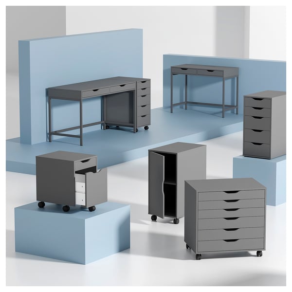 A modern grey ALEX desk and storage units on blue platforms. The units feature multiple drawers and a clean, sleek design.