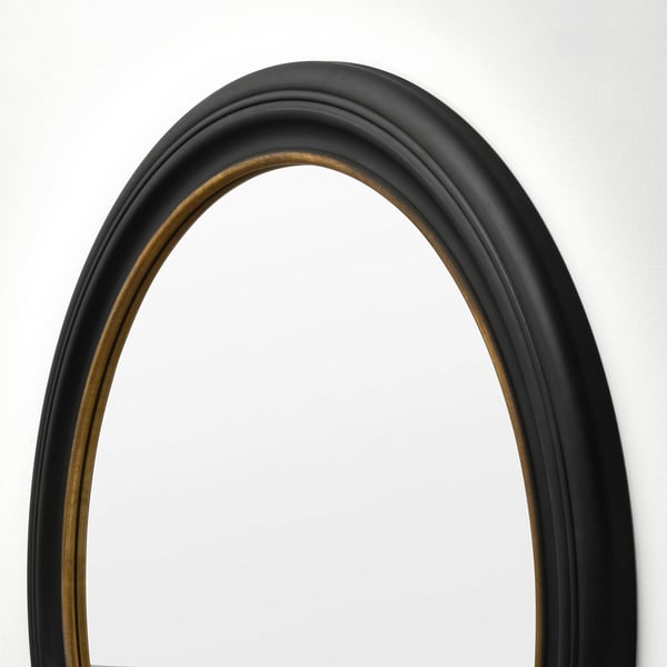 Elegant ALMARÖD mirror with black frame and gold trim, reflecting quality and style.