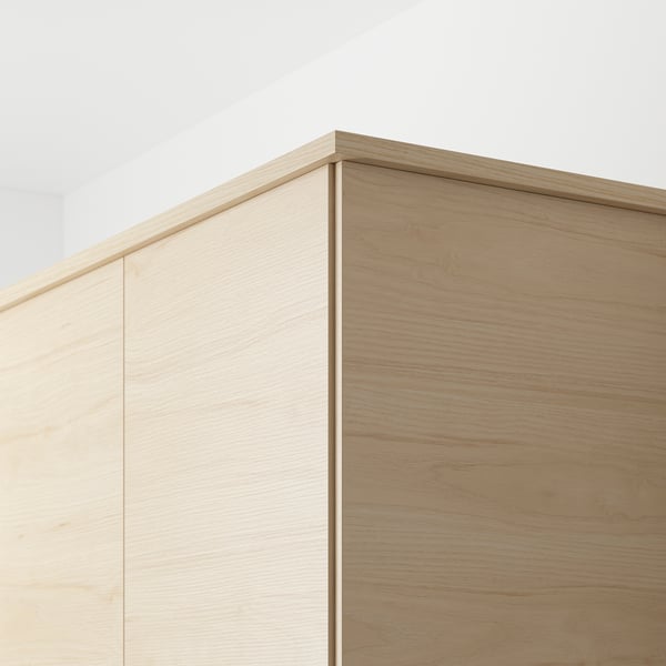 Close-up of ASKERSUND light ash panels, showcasing easy-clean melamine surface and wood pattern, ideal for hiding kitchen lighting fixtures and cords.