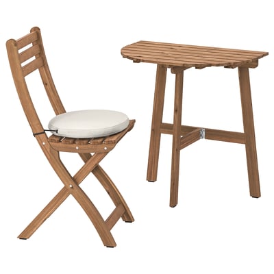 ASKHOLMEN: wooden outdoor table and folding chair with cushion. Natural brown, durable acacia wood.